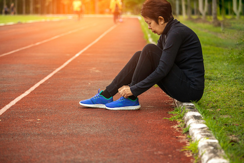 Woman putting on running shoes